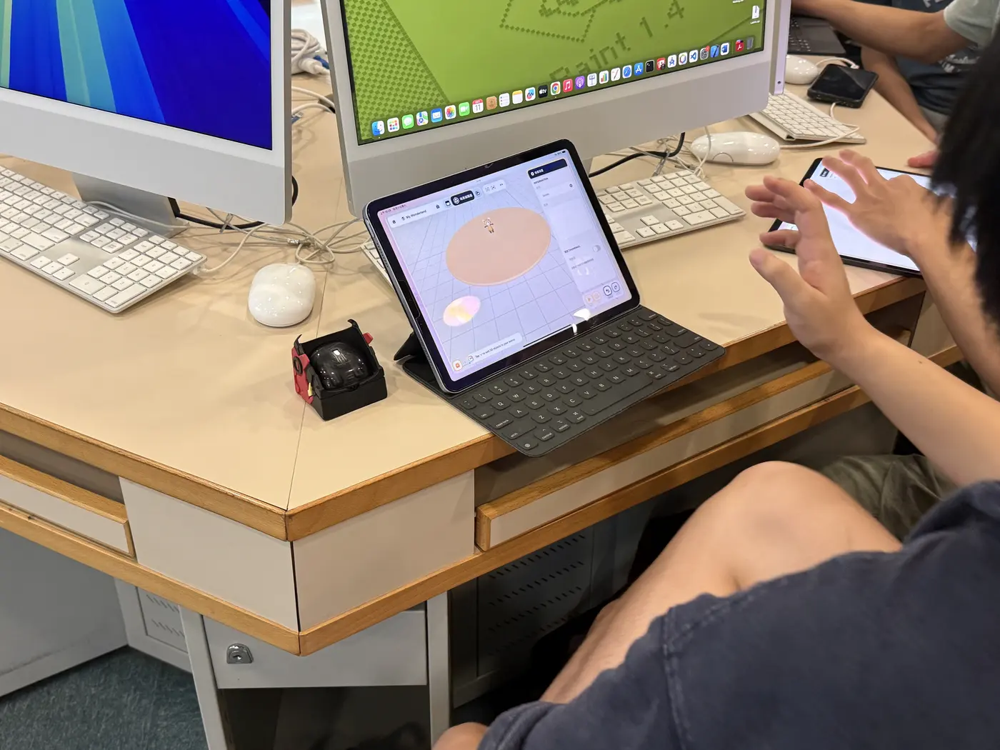 Students in a computer room working on iPads and computers