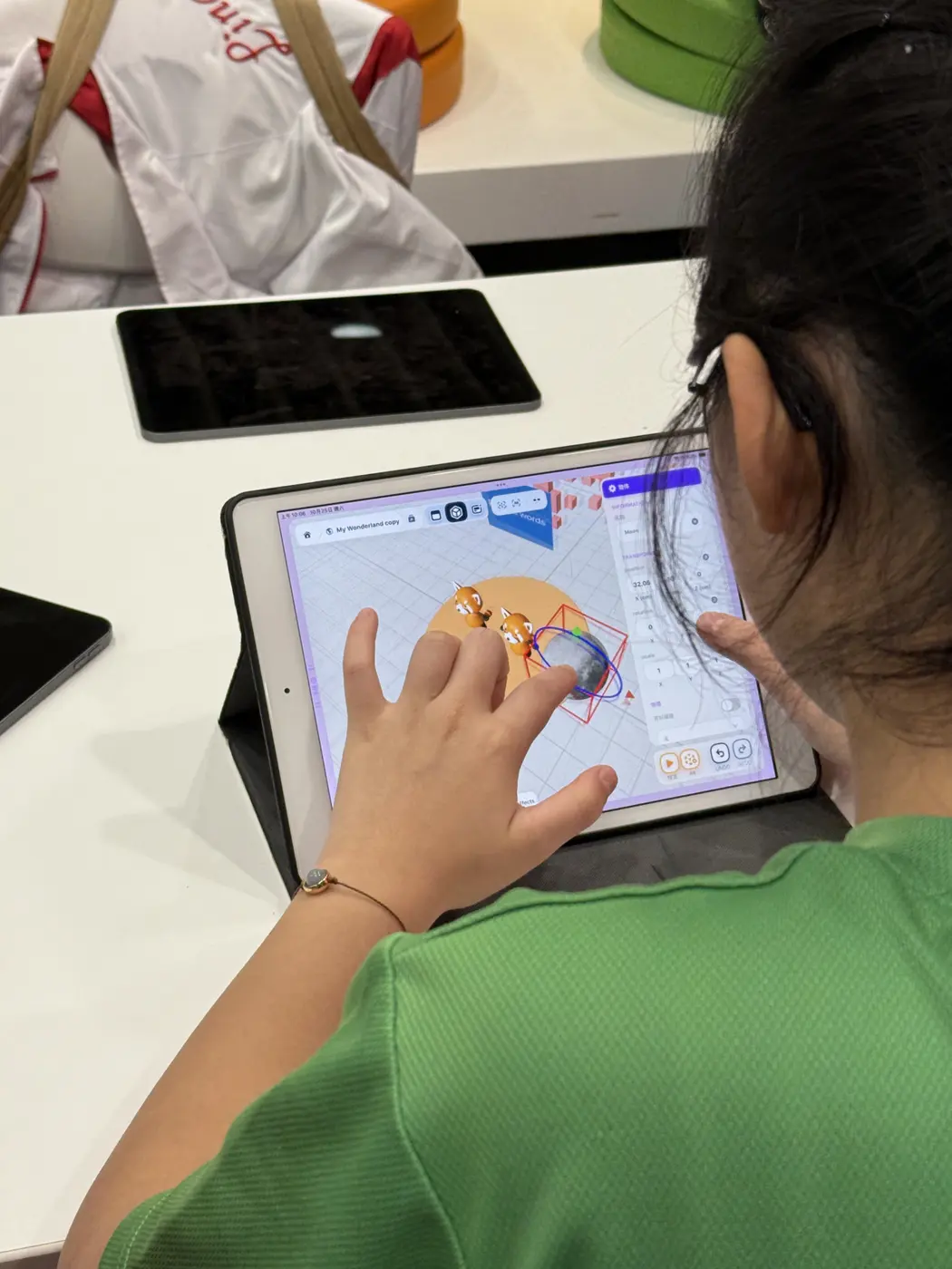 A student adjusting a 3D object on an iPad