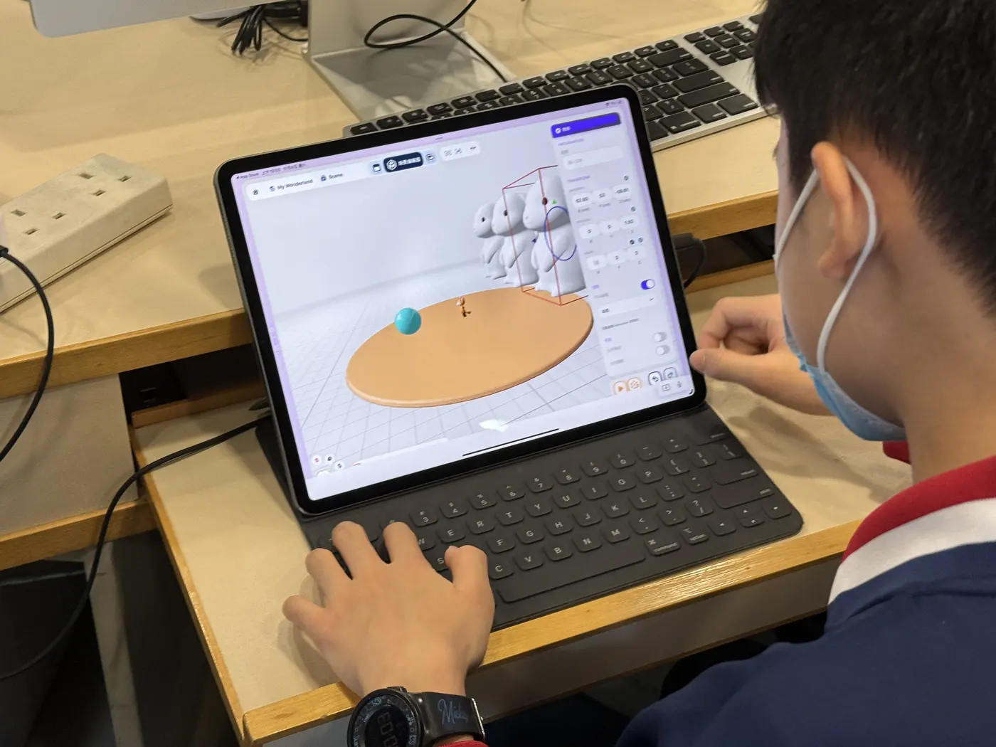 A student editing a 3D scene in Wonderland on an iPad